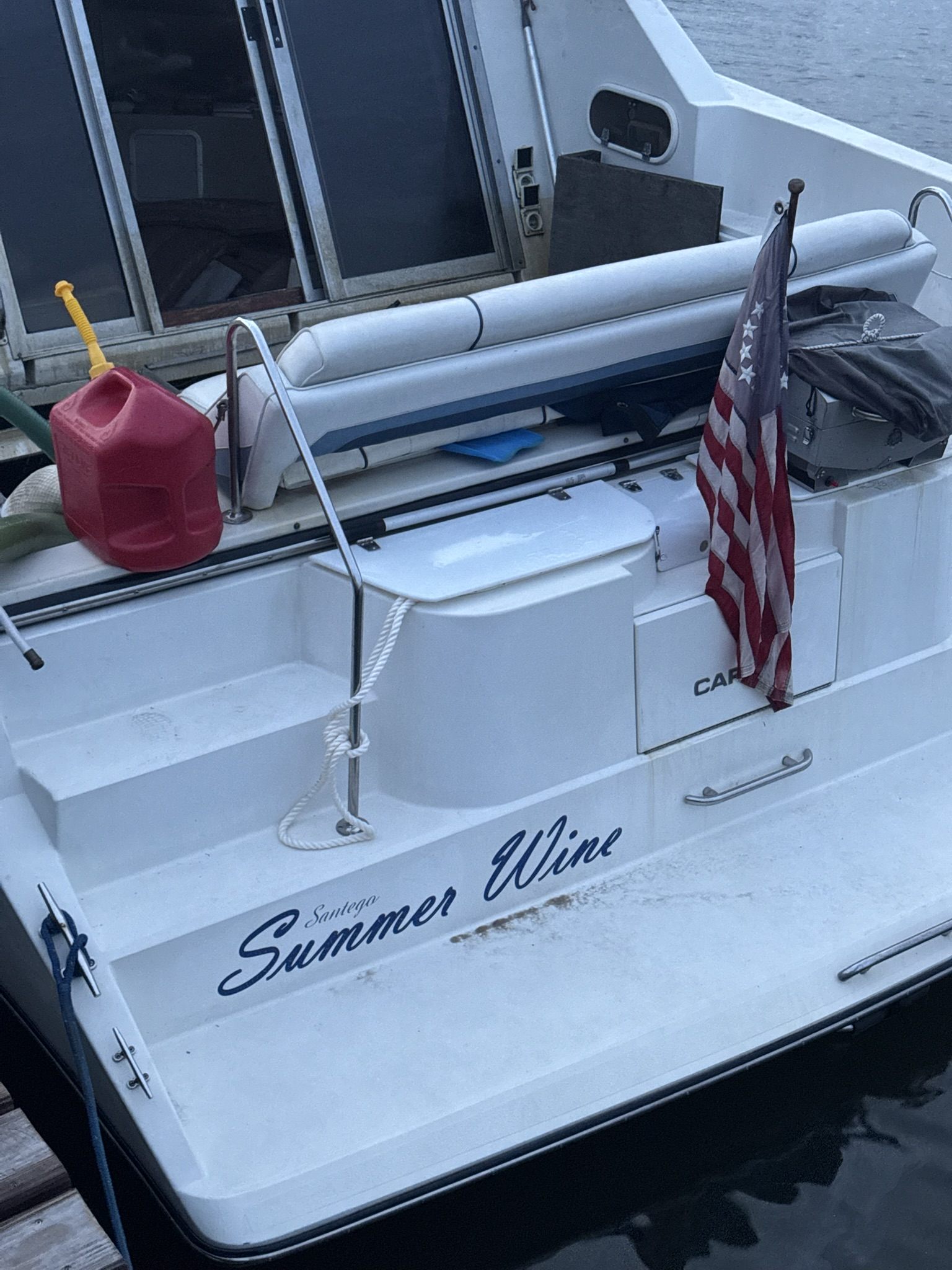 Stern recovery lines and dock setup beside a recovered cabin cruiser