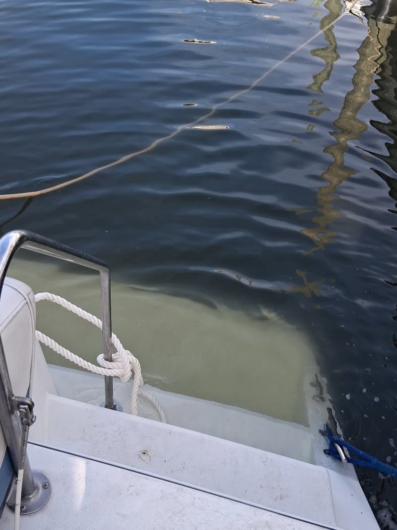 Detail view of waterline and cabin damage after a flooded boat recovery